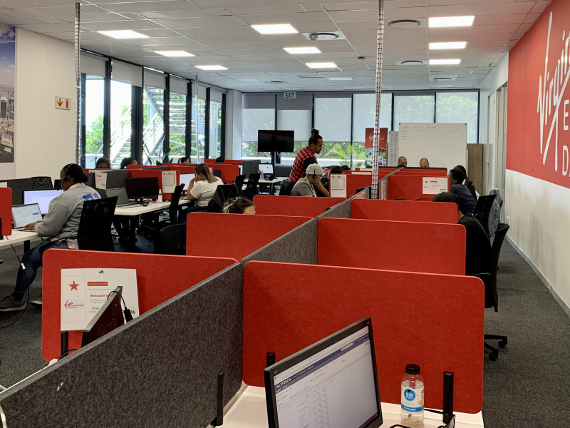 White desks with red and grey screens